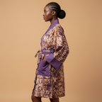 Woman wearing a patterned robe with purple accents on a beige background