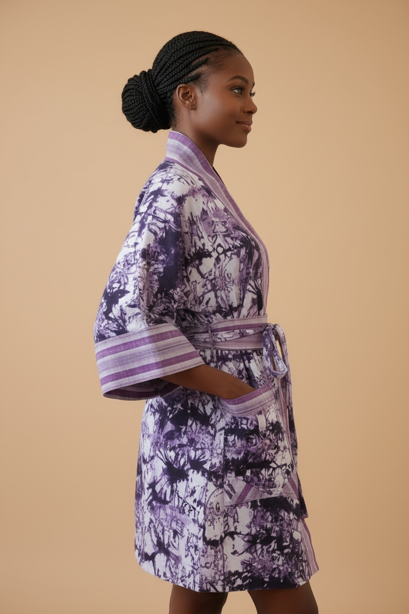 Woman wearing a purple and white patterned robe against a beige background
