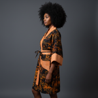 Woman wearing a patterned robe against a gray background