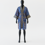 Mannequin wearing a blue and brown patterned robe on a white background