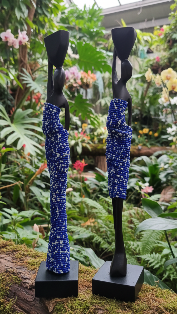 Two statues with blue bead-like patterns on a natural background