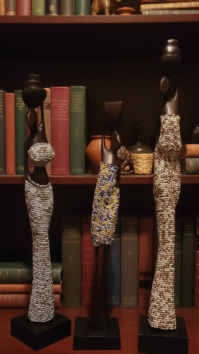 Decorative figurines on stands against a bookshelf background