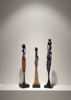 Three statues of women in various poses on a white background