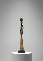 Small sculpture on a white pedestal against a gray background