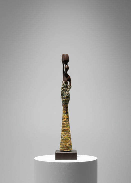 Small sculpture on a white pedestal against a gray background
