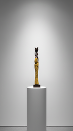 Statue on a white pedestal against a gray background