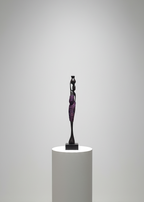 Sculpture on a white pedestal against a plain wall
