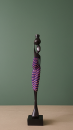 Decorative sculpture with a purple and black design on a beige surface and green background