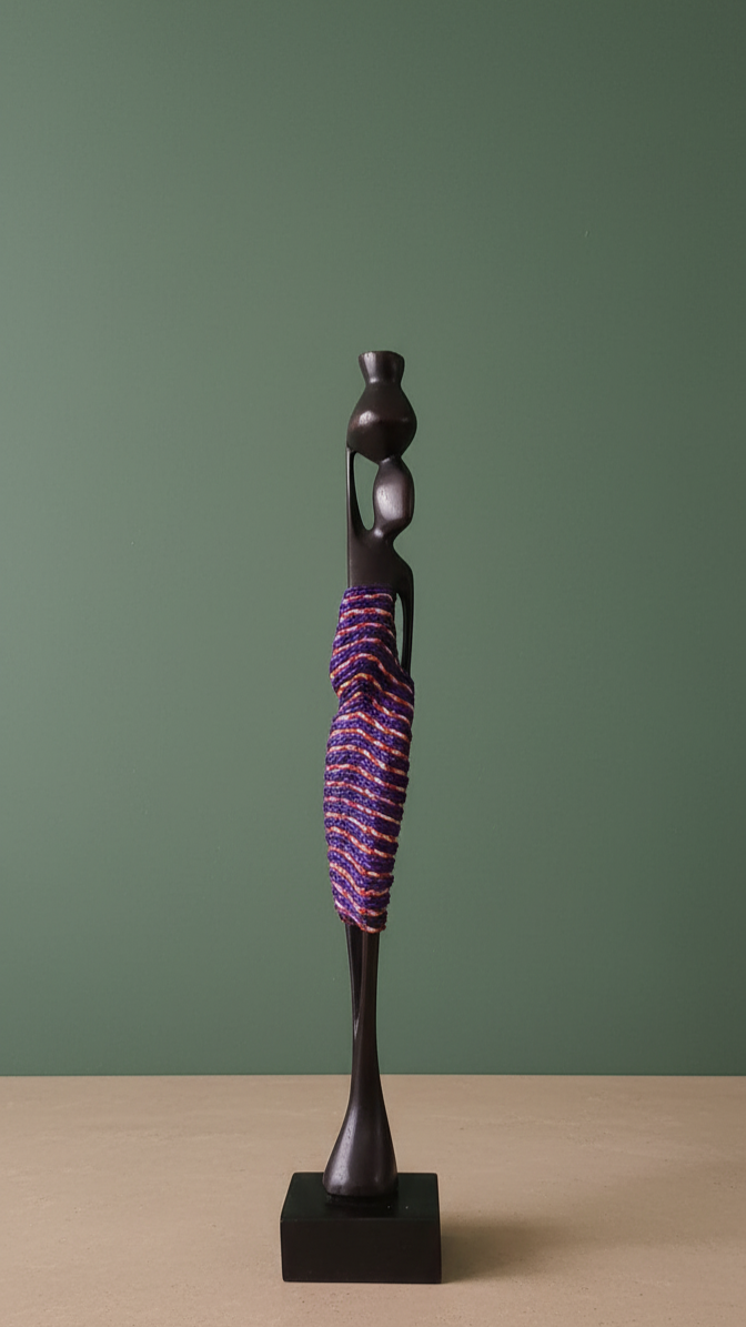 Decorative sculpture with a purple and black design on a beige surface and green background