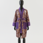 Purple and brown patterned robe on a mannequin against a white background