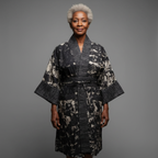 Woman wearing a patterned robe against a gray background